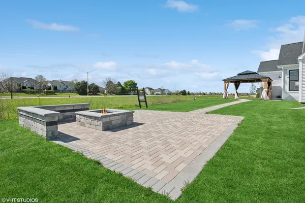 a view of a house with a yard and a park