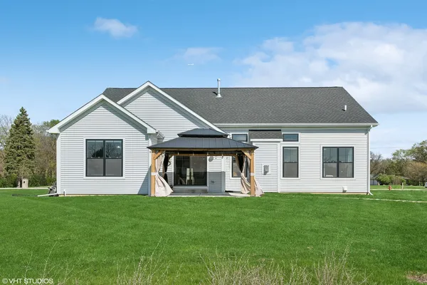a front view of house with yard and green space