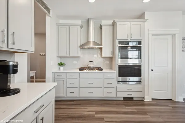 a kitchen with stainless steel appliances white cabinets and a sink