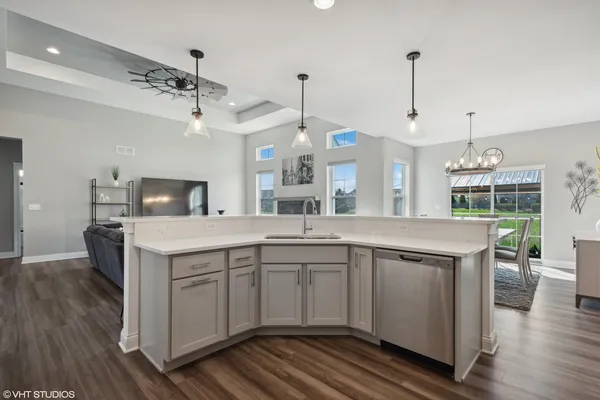 a kitchen with a sink center island and stainless steel appliances