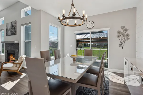 a view of a dining room with furniture wooden floor and a chandelier