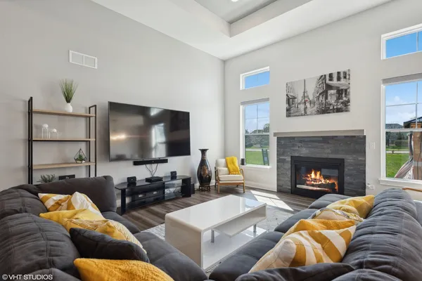 a living room with furniture and a fireplace