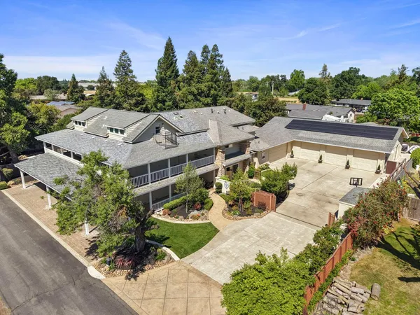 an aerial view of a house with a big yard