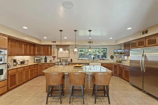 a kitchen with granite countertop a sink and cabinets