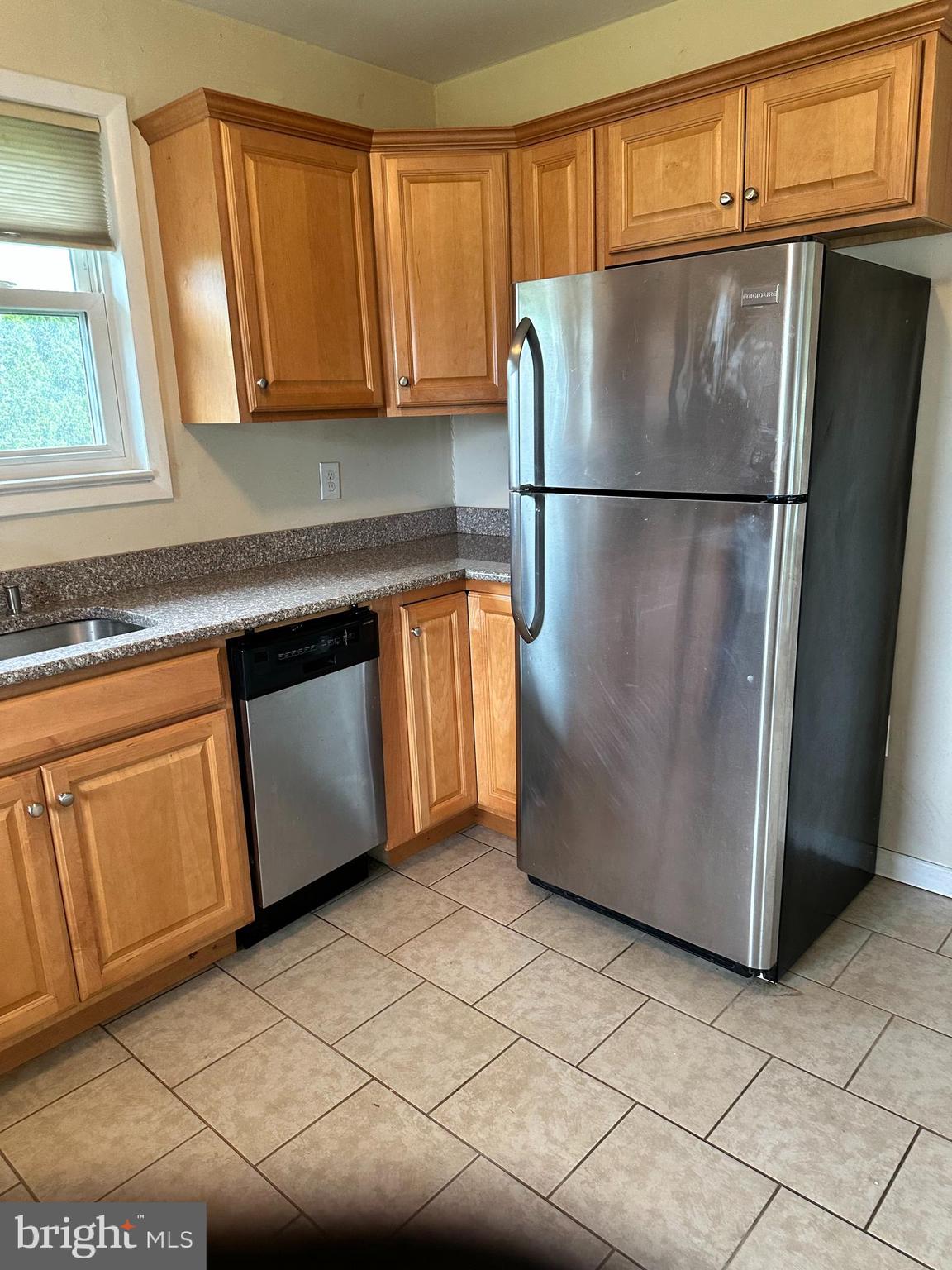 102 Myrtle Avenue Reading, PA 19606 - Photo 5 of 11 a kitchen with stainless steel appliances granite countertop a refrigerator a microwave and a sink