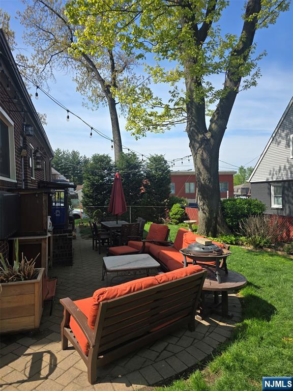 585 Monroe Place Ridgefield, NJ 07657 - Photo 25 of 28 a backyard of a house with outdoor seating