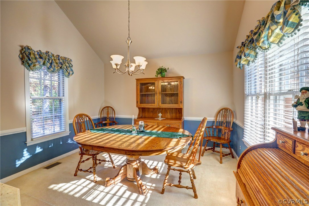 13601 Queensgate Road Midlothian, VA 23114 - Photo 16 of 39 a dining room with furniture a chandelier and wooden floor