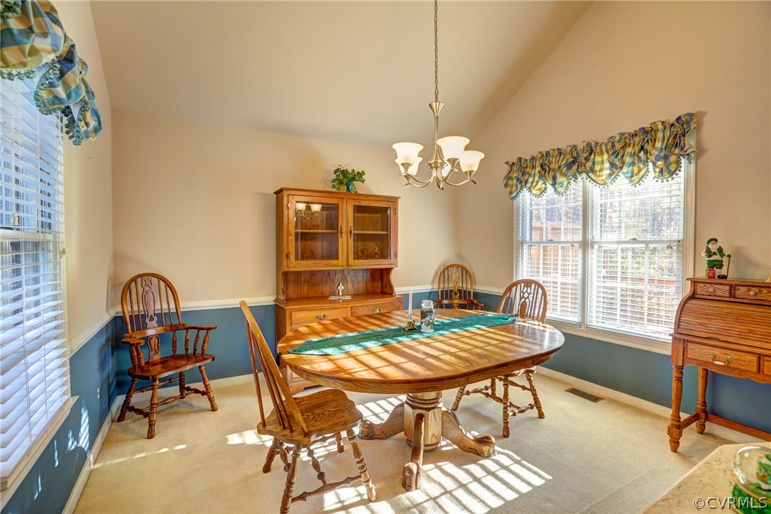 13601 Queensgate Road Midlothian, VA 23114 - Photo 17 of 39 a view of a dining room with furniture a chandelier and wooden floor