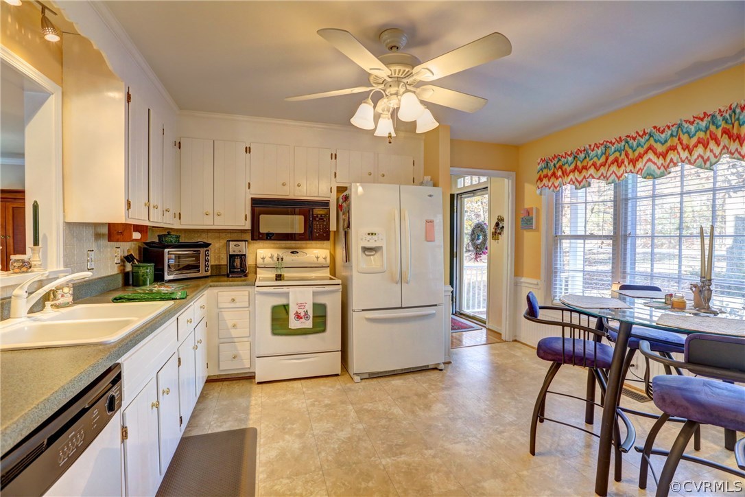 13601 Queensgate Road Midlothian, VA 23114 - Photo 19 of 39 a kitchen with stainless steel appliances a stove a sink dishwasher a refrigerator with a dining table and chairs with wooden floor