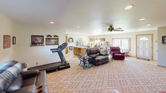 a living room with furniture gym equipment and a flat screen tv