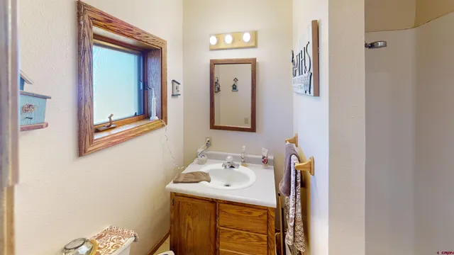 a bathroom with a sink a mirror and a toilet