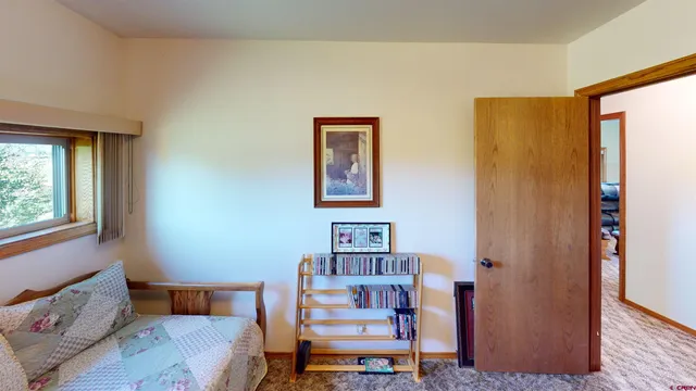 a reading room with furniture and a window