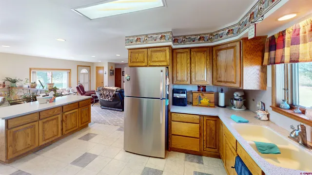 a kitchen with a refrigerator a sink dishwasher stove and oven
