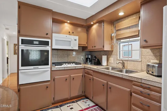 a kitchen with stainless steel appliances granite countertop a sink and cabinets