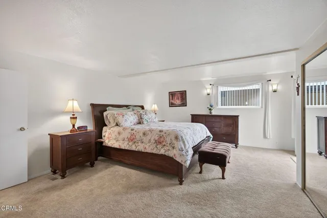 a spacious bedroom with a bed and a table