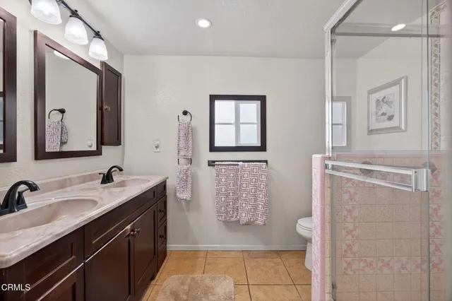 a bathroom with a sink a toilet and mirror