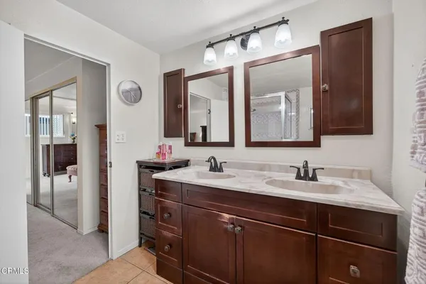 a bathroom with a double vanity sink and a mirror