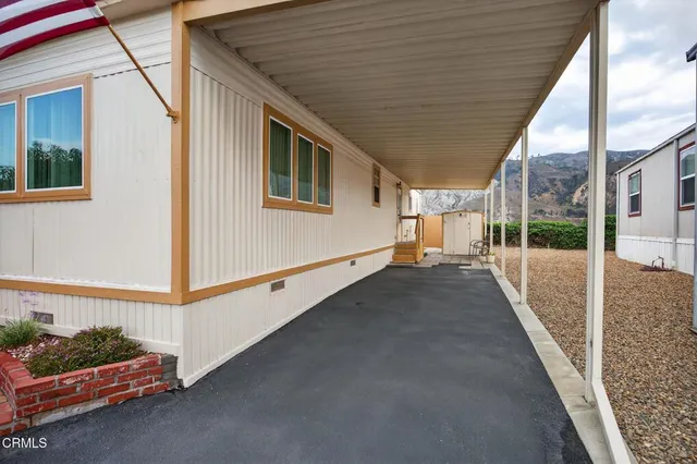 a view of wooden house with a wooden fence