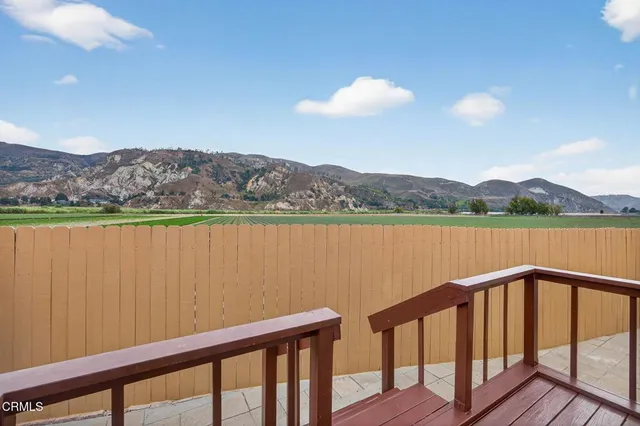 a balcony with wooden floor and lake view