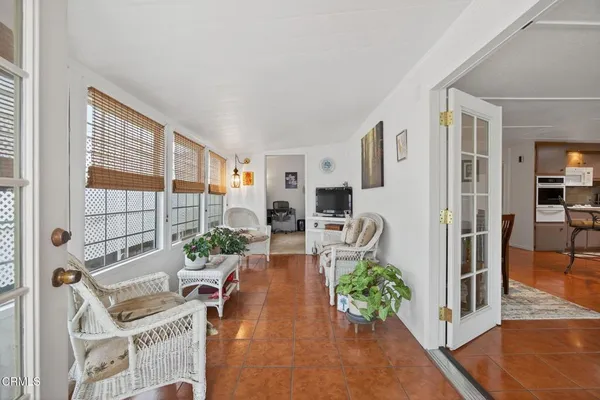 a living room with furniture a rug and a window