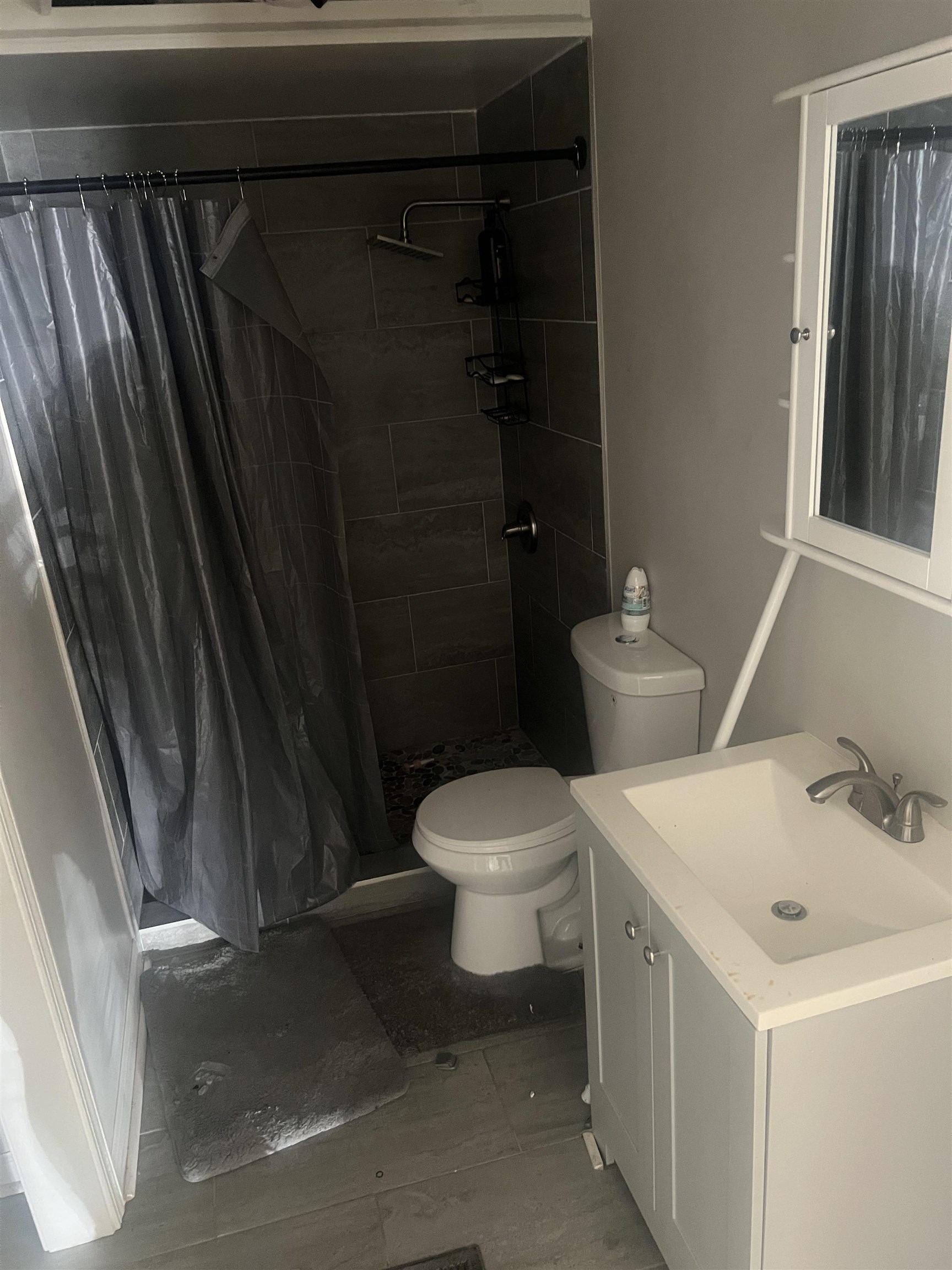 1353 Harbert Avenue Memphis, TN 38104 - Photo 12 of 18 a white toilet sitting next to a bathroom sink