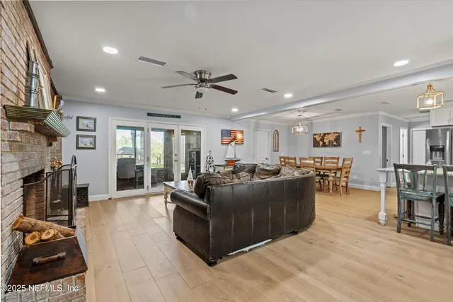 a living room with furniture a window and a kitchen view