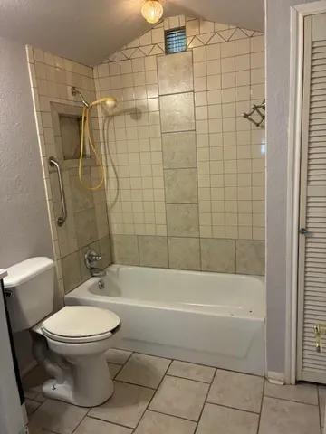 a bathroom with a toilet and a shower