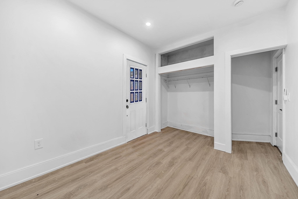 92 Willow Street, Unit 3 Cambridge, MA 02141 - Photo 15 of 17 a view of an empty room with wooden floor