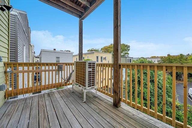 a view of balcony with wooden floor & fence