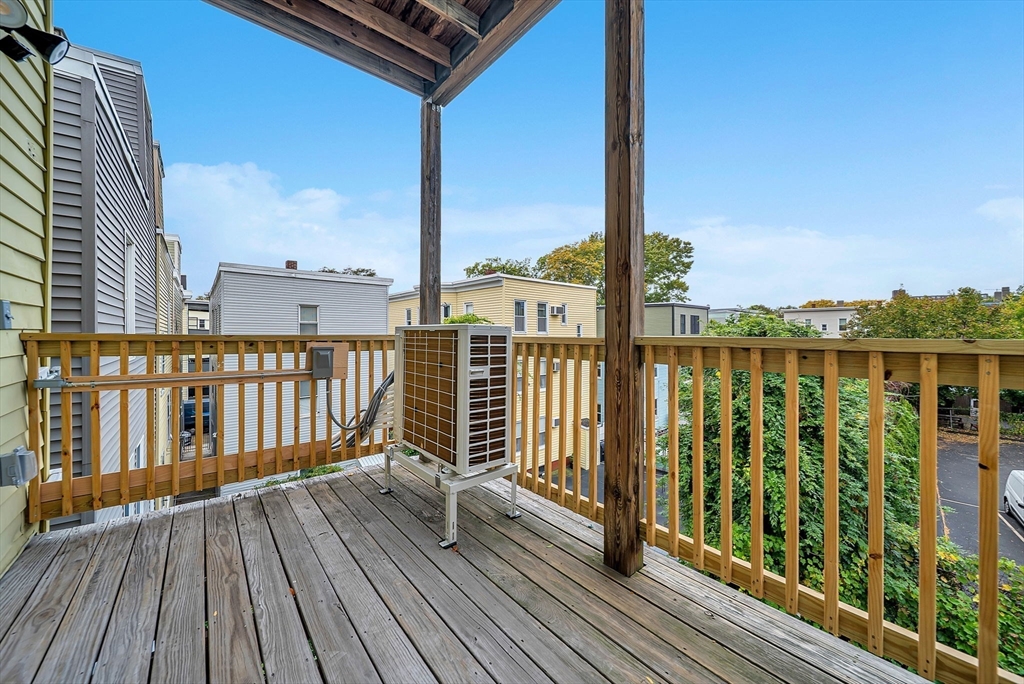 92 Willow Street, Unit 3 Cambridge, MA 02141 - Photo 17 of 17 a view of balcony with wooden floor & fence