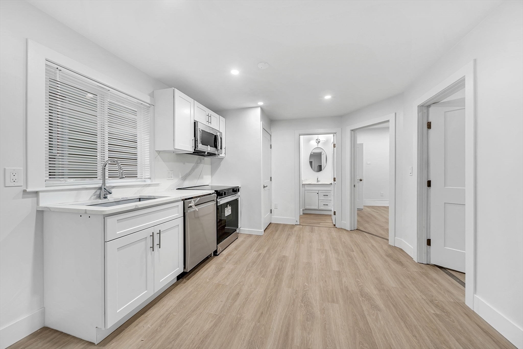 92 Willow Street, Unit 3 Cambridge, MA 02141 - Photo 5 of 17 a view of a kitchen with a sink a refrigerator and window