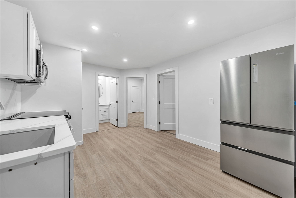92 Willow Street, Unit 3 Cambridge, MA 02141 - Photo 6 of 17 a view of a kitchen with a sink and a refrigerator