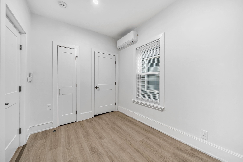 92 Willow Street, Unit 3 Cambridge, MA 02141 - Photo 8 of 17 a view of an empty room with wooden floor and a window