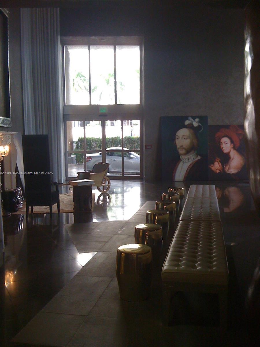 485 Brickell Avenue, Unit 2606 Miami, FL 33131 - Photo 8 of 18 a living room with furniture and a floor to ceiling window