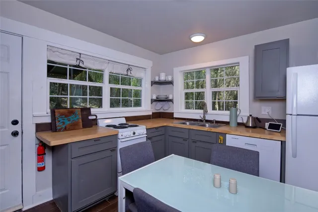 a kitchen with a sink stove and cabinets