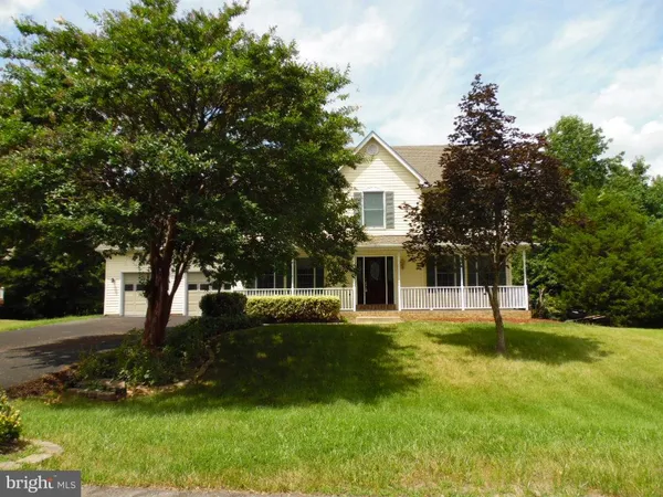 a view of a house with a yard and tree s