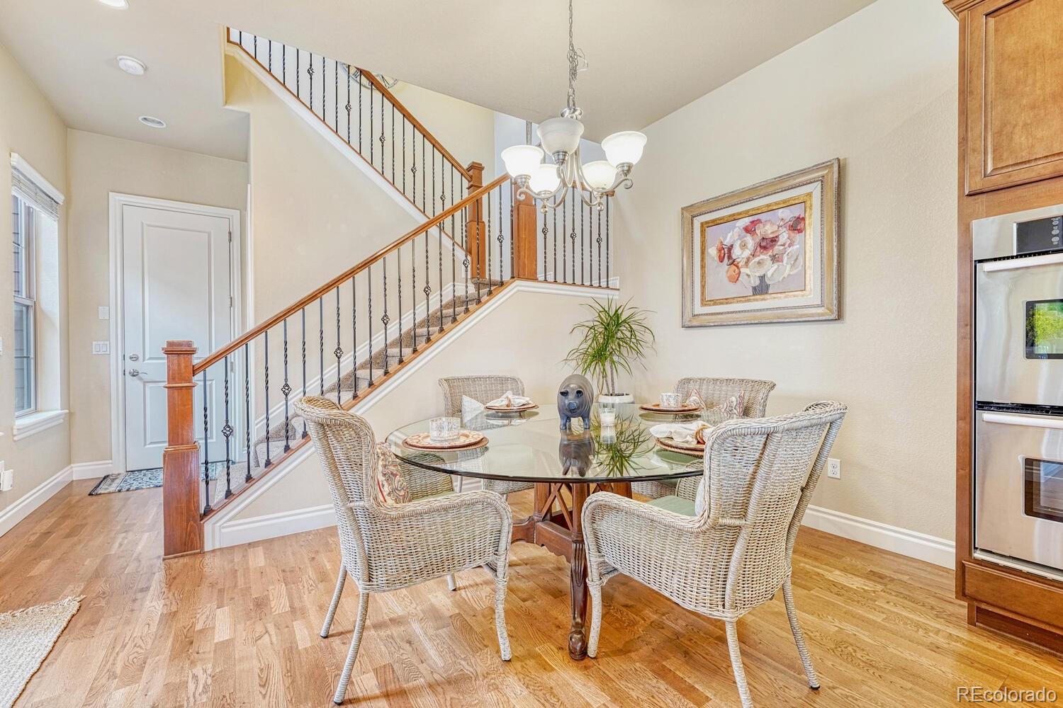 10120 RidgeGate Circle Lone Tree, CO 80124 - Photo 11 of 25 a view of a dining room with furniture wooden floor and chandelier