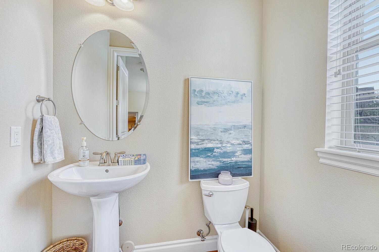 10120 RidgeGate Circle Lone Tree, CO 80124 - Photo 12 of 25 a bathroom with a toilet sink and mirror