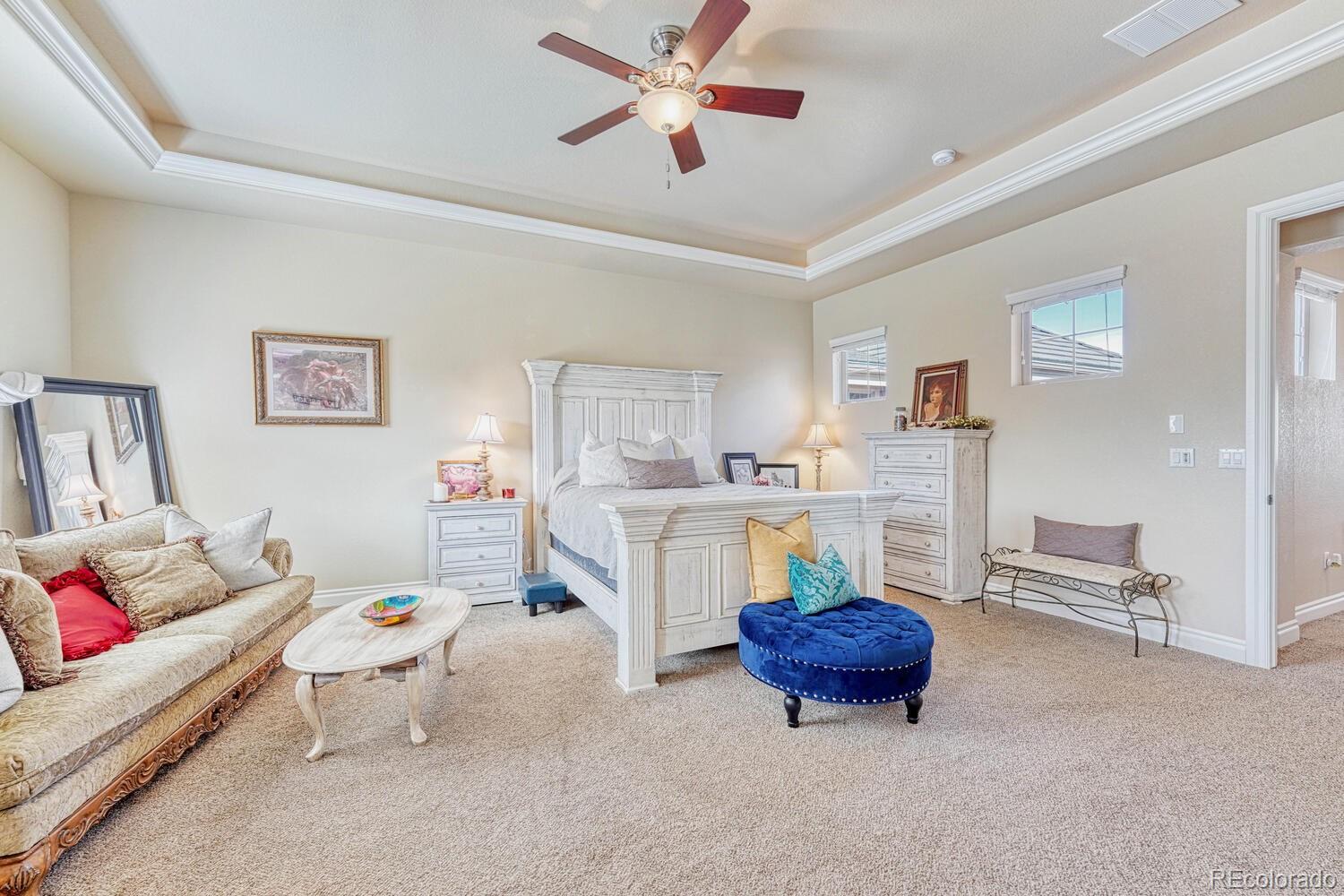 10120 RidgeGate Circle Lone Tree, CO 80124 - Photo 15 of 25 a living room with furniture a rug and a chandelier