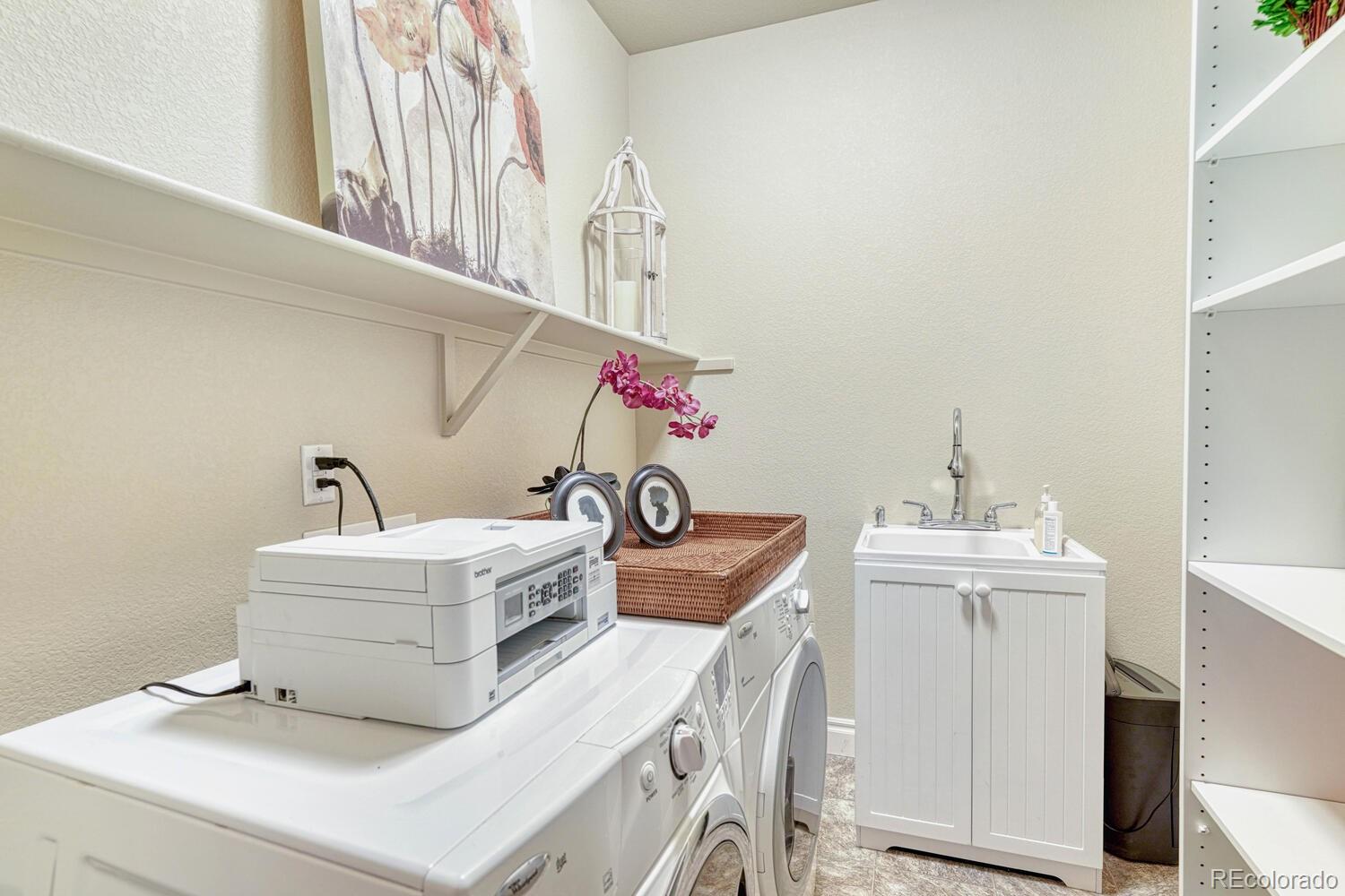 10120 RidgeGate Circle Lone Tree, CO 80124 - Photo 22 of 25 a bathroom with a sink a vanity and a mirror