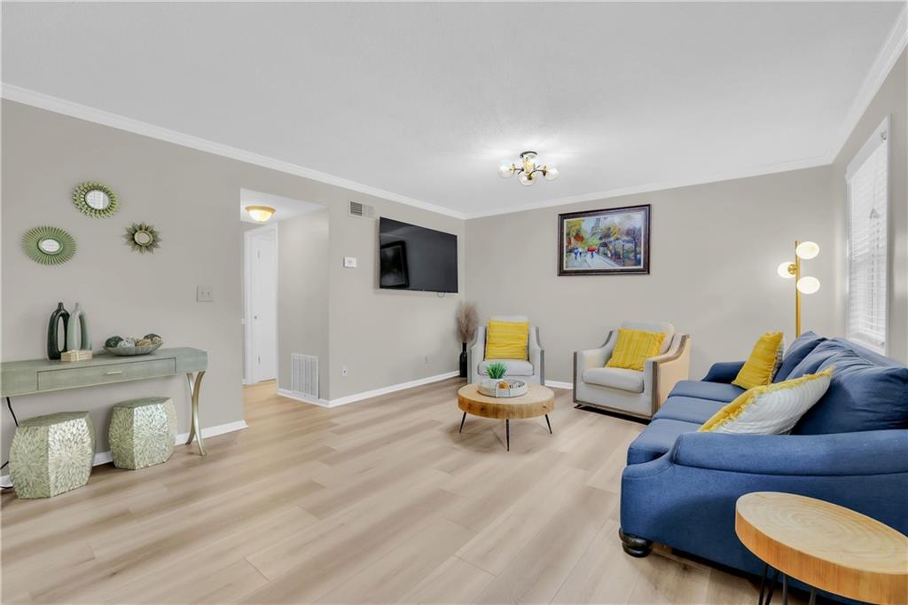 6900 Roswell Road, Unit E2 Atlanta, GA 30328 - Photo 1 of 1 a living room with furniture and wooden floor
