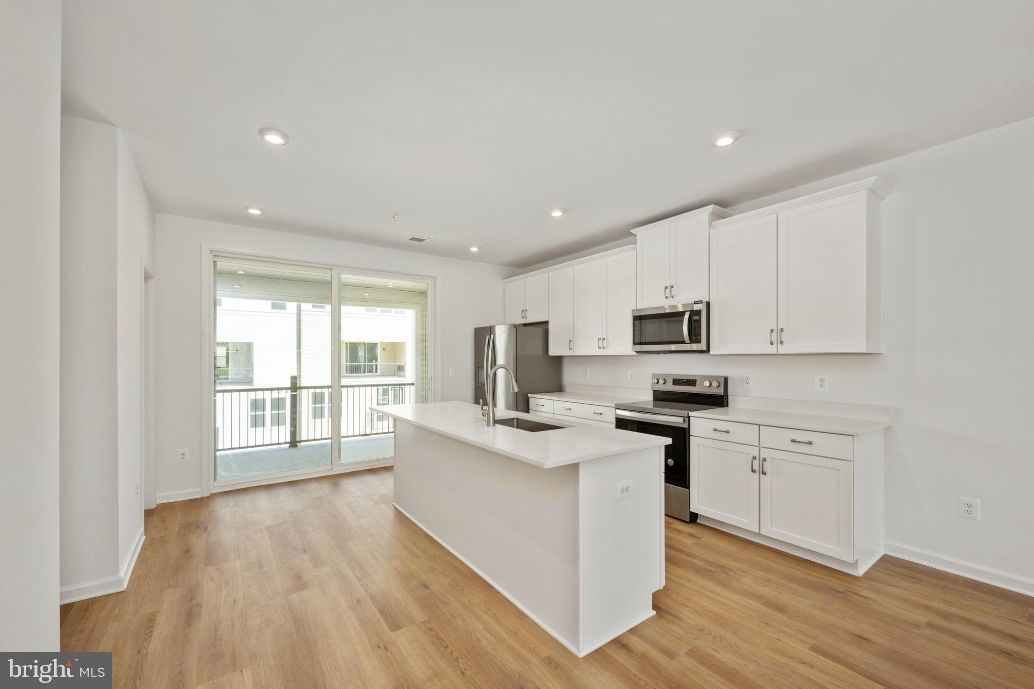 2518 Neabsco Common Place Woodbridge, VA 22191 - Photo 10 of 37 a kitchen with stainless steel appliances granite countertop a stove top oven a sink dishwasher and a refrigerator with wooden floor