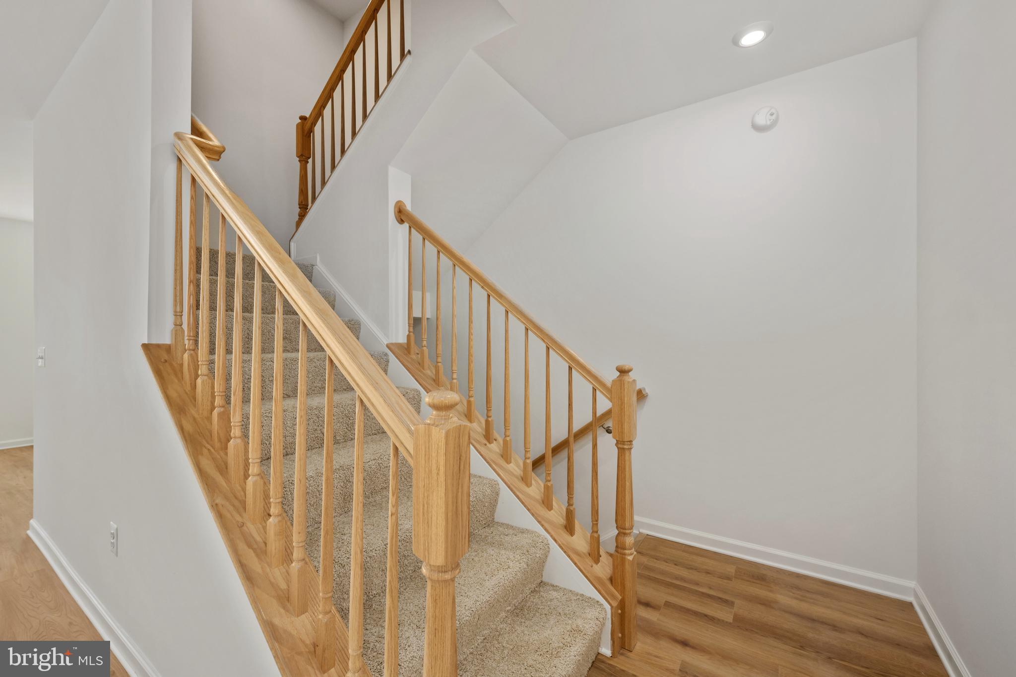 2518 Neabsco Common Place Woodbridge, VA 22191 - Photo 15 of 37 a view of staircase with wooden floor and white walls