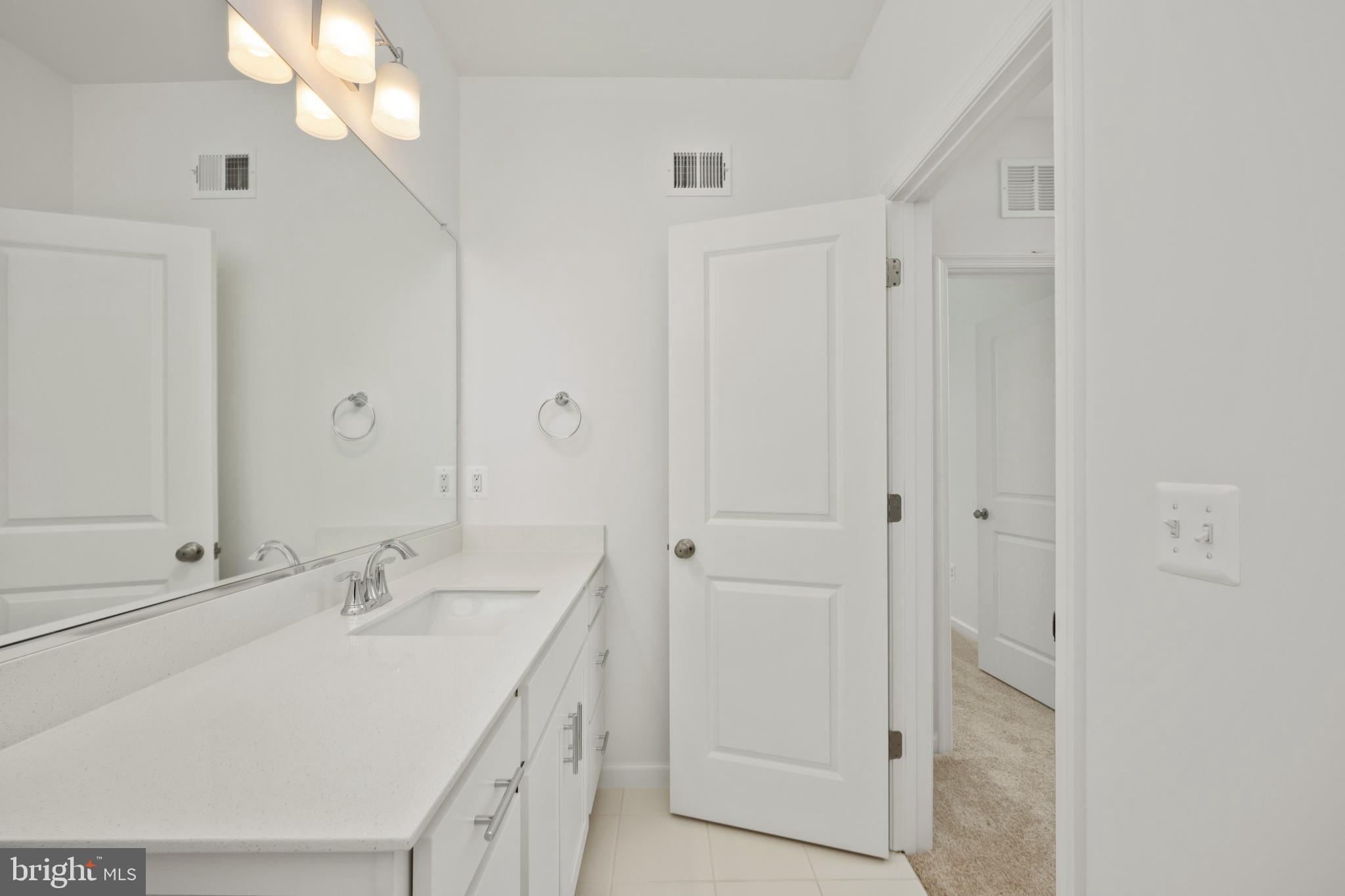 2518 Neabsco Common Place Woodbridge, VA 22191 - Photo 18 of 37 a bathroom with a sink vanity and a mirror