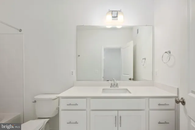 a bathroom with a sink vanity and a mirror