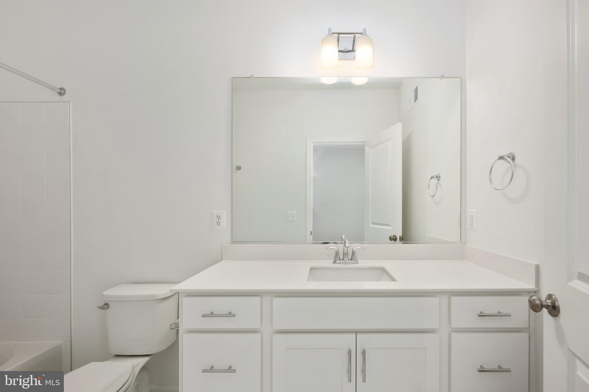 2518 Neabsco Common Place Woodbridge, VA 22191 - Photo 19 of 37 a bathroom with a sink toilet vanity and mirror