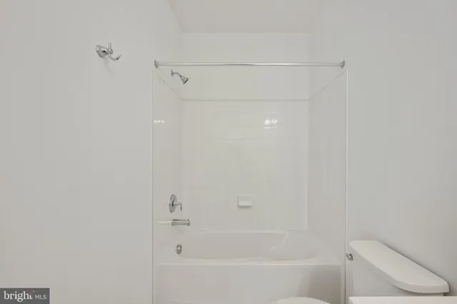 a bathroom with a sink toilet vanity and mirror