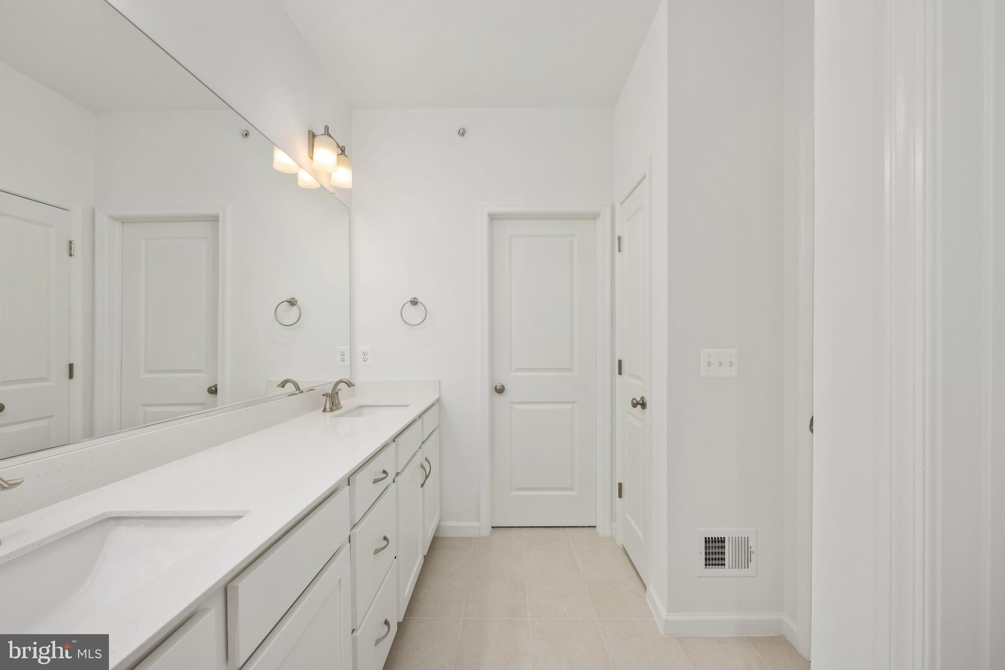 2518 Neabsco Common Place Woodbridge, VA 22191 - Photo 30 of 37 a spacious bathroom with a double vanity sink and a mirror