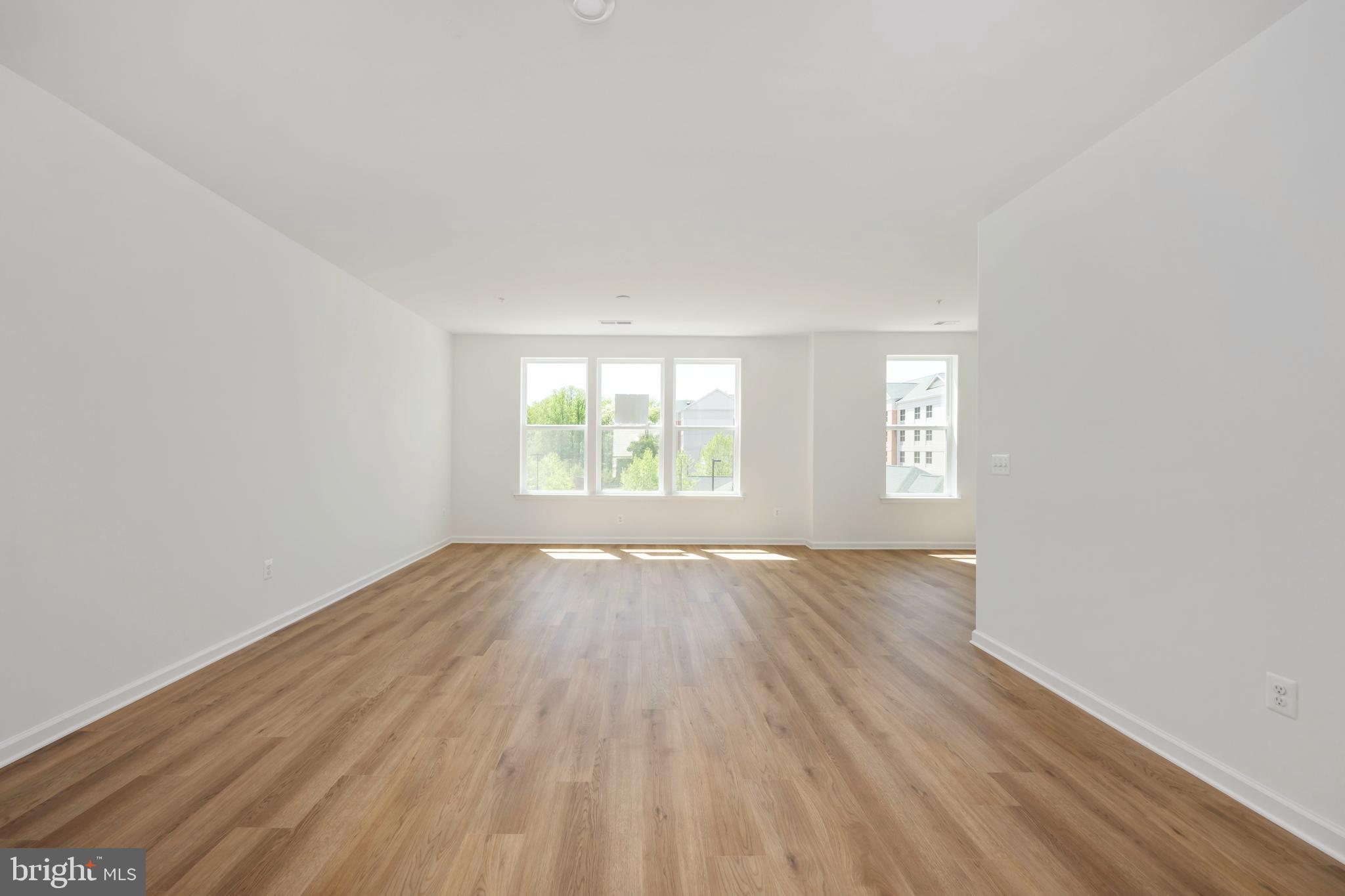 2518 Neabsco Common Place Woodbridge, VA 22191 - Photo 3 of 37 an empty room with wooden floor and windows