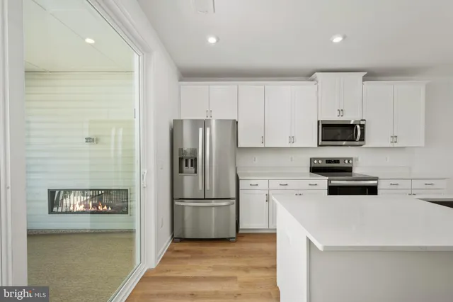 a kitchen with stainless steel appliances a refrigerator stove microwave and sink